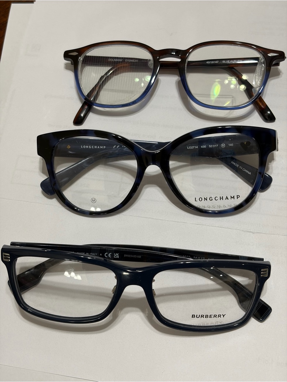 Burberry, Longchamp and one other pair of designer Frames.
